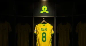 Mamelodi Sundowns Retire No. 8 Shirt in Honour of Late Jayden Adams Jayden Adams. Jayden Adams jersey. Jayden Adams number 8. Mamelodi Sundowns. Sundowns retire number 8. Jayden Adams tribute. Jayden Adams legacy. Mamelodi Sundowns news. Sundowns news 2026. Jayden Adams death. Bafana Bafana. South African football. PSL news. Mzansi football. Sundowns 2026/27.